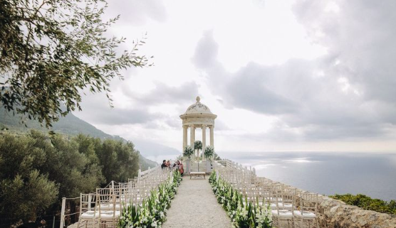 Ceremony aisle lined with white flowers leading to the iconic Son Marroig rotunda overlooking the Mediterranean in the Serra de Tramuntana
